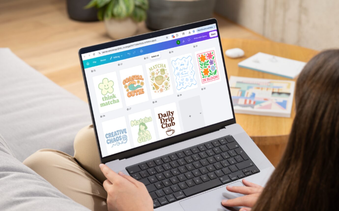 Canva open on a laptop with a set of merch designs ready to export