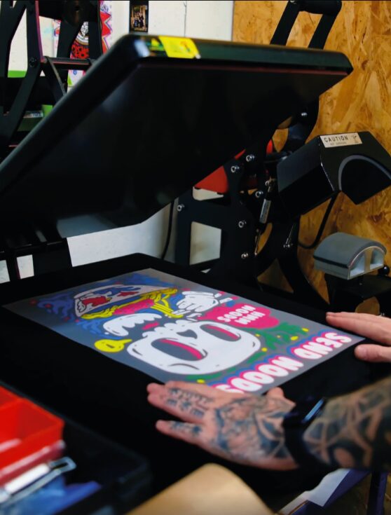 Pressing a full-colour Supacolour Wearable transfer onto a black tee at Modern Streets